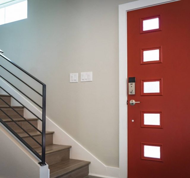 Red Wooden Door Beside Stairs