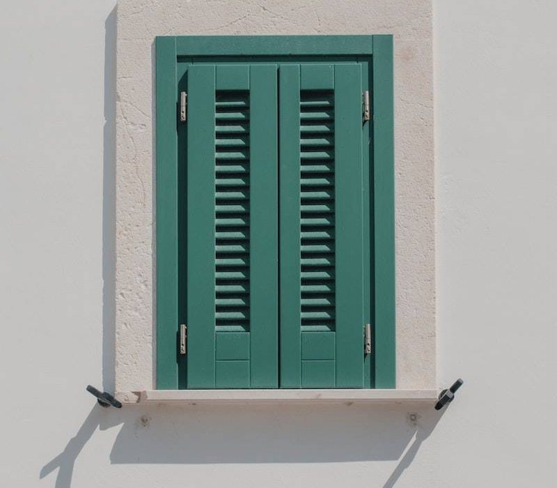 green wooden window on white wall